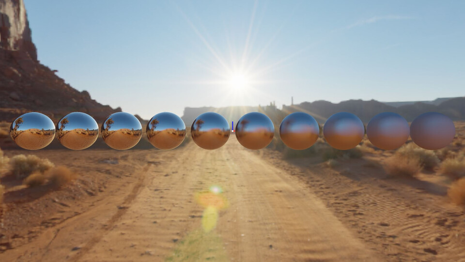 Row of metal spheres from smooth to rough on a desert road